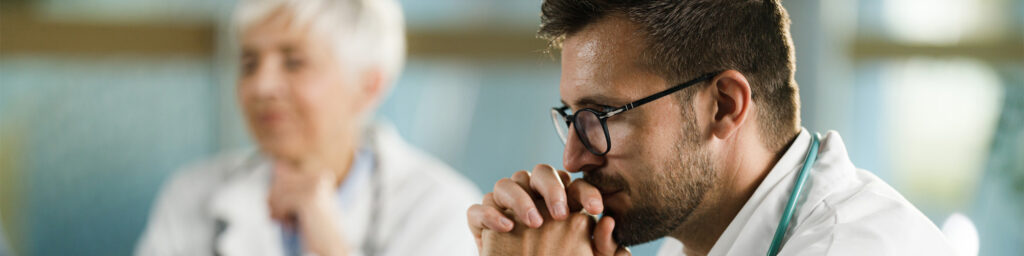 Worried male doctor in the office.