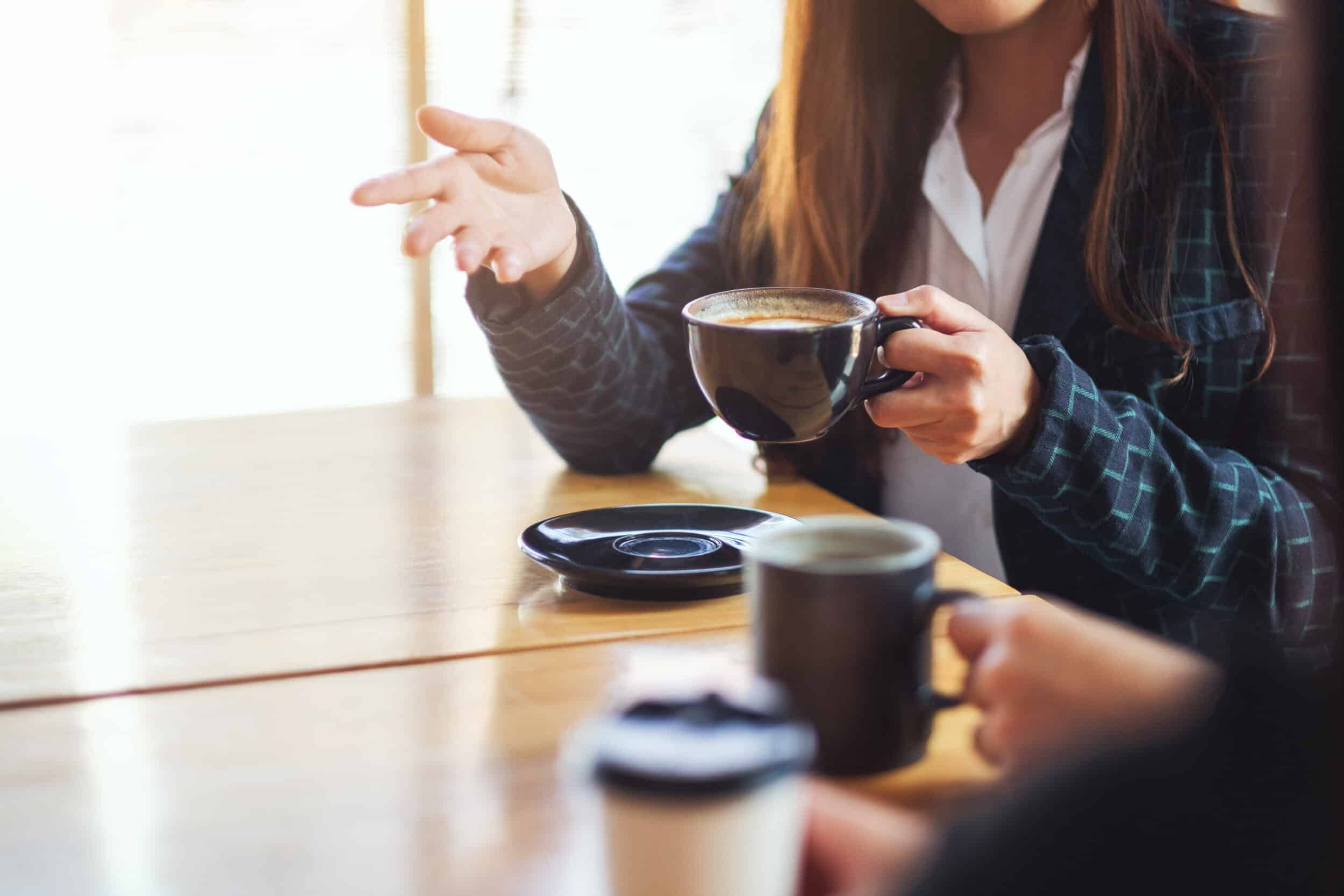 people enjoyed talking and drinking coffee together in cafe people enjoyed talking and drinking coffee together in cafe