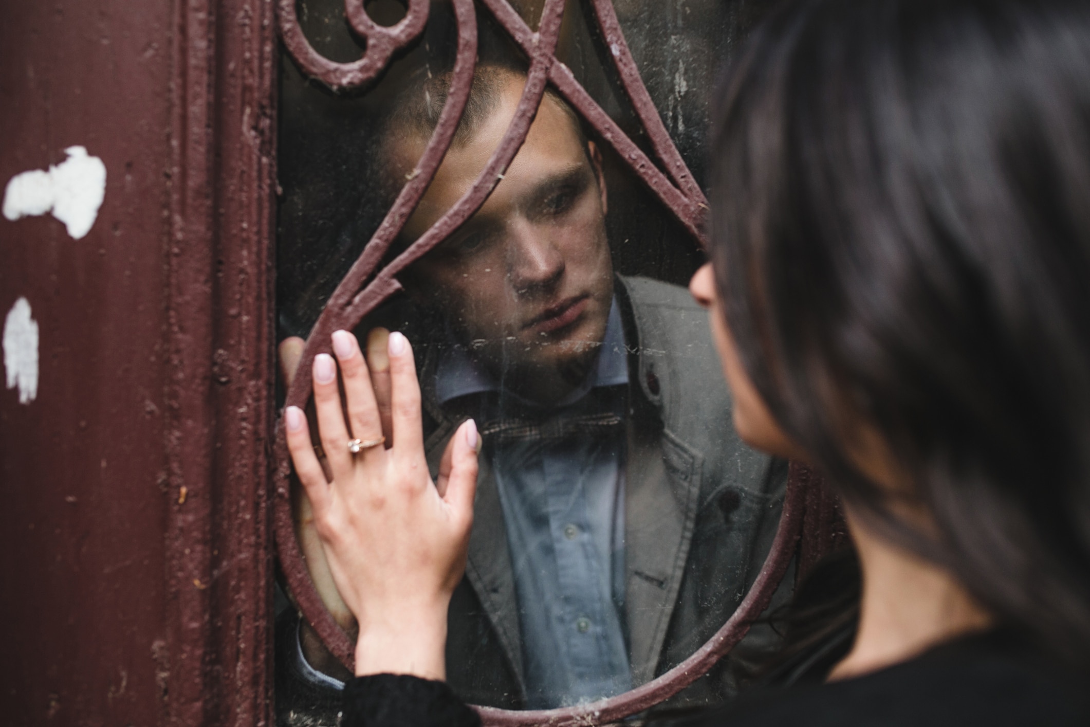 couple looking at each other through the window
